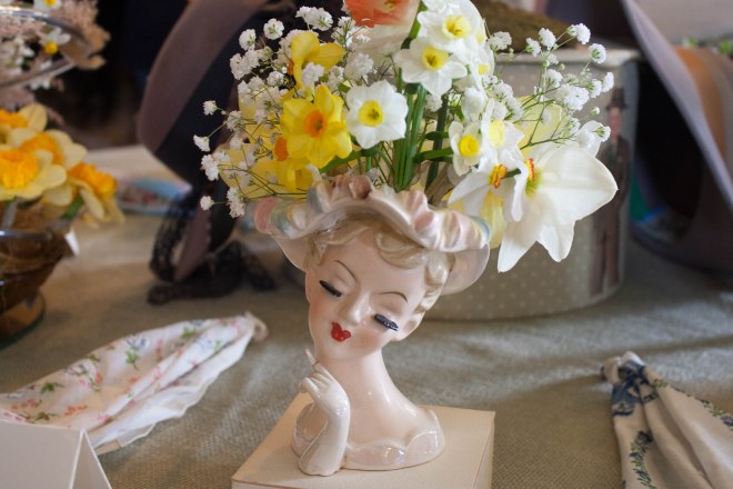 daffodils and baby's breath in a lady-head vase